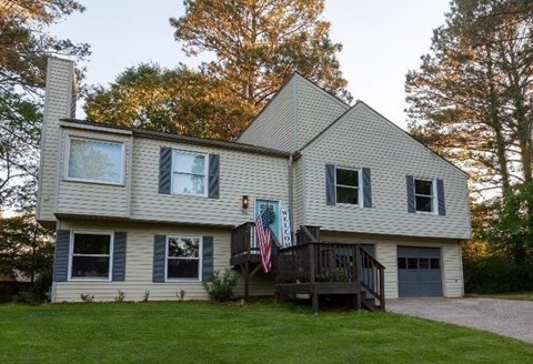 a house with a deck and a flag on it